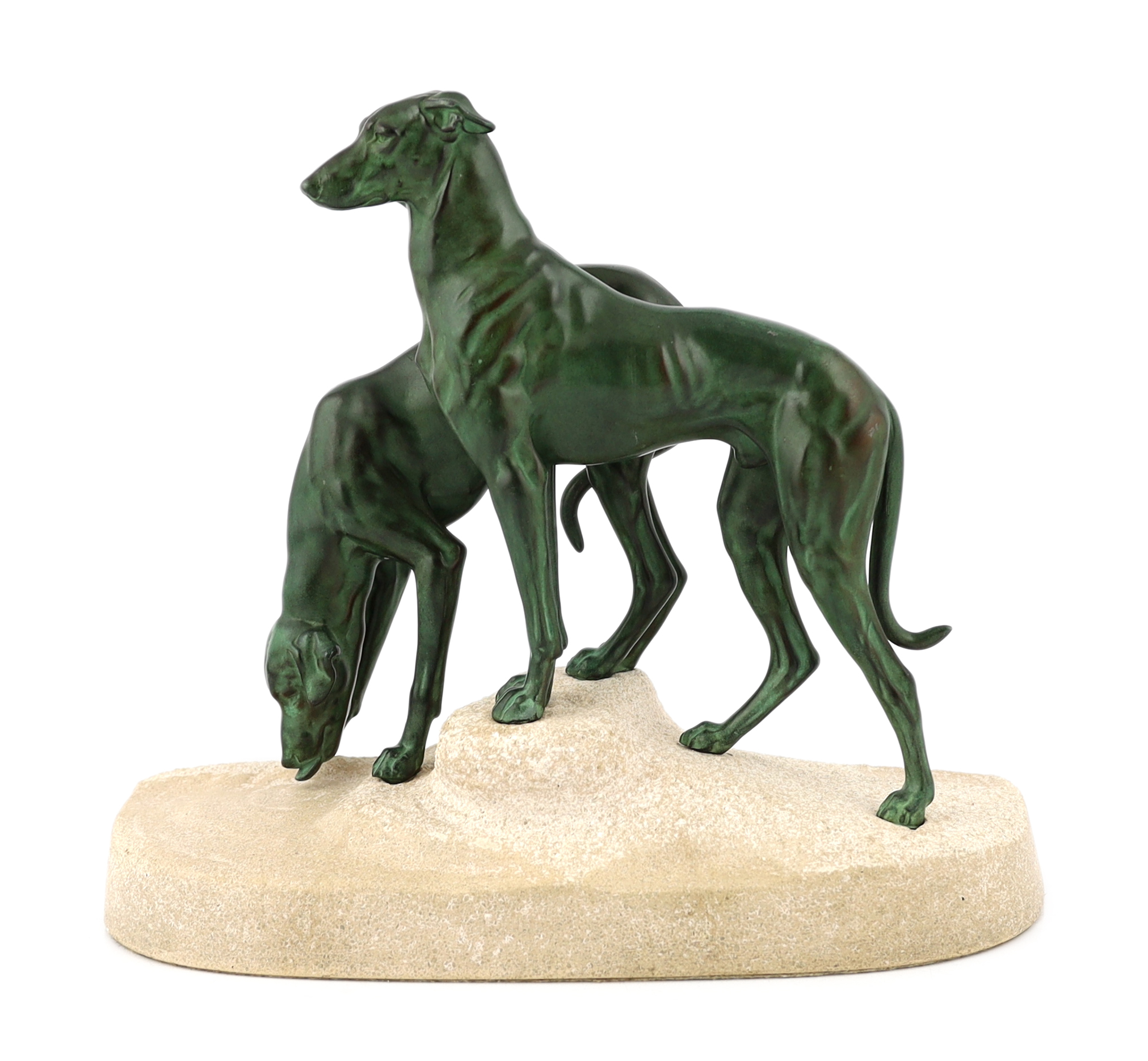 Masson, a French Art Deco spelter and composition stone group of two hounds watering, signed in the base, 32cm long, 12cm deep, 28cm high